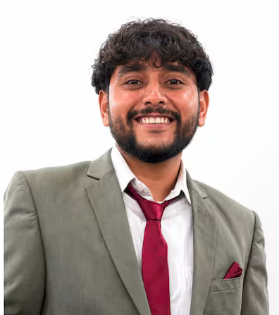 Purvansh Parmar, Platform Engineer, photographed in a grey suit against a white background